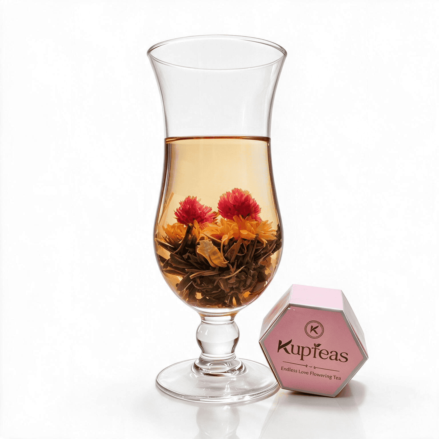 Flowering tea with pink and yellow blossoms in a glass cup.